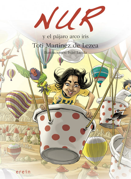 Libro Nur Y El Pájaro Arco Iris: Pronto serán las fiestas de Bilbao y Nur se encuentra de vacaciones en Larrabetzu. Una tarde, sus padres y ella, hacen planes para ir a las barracas.